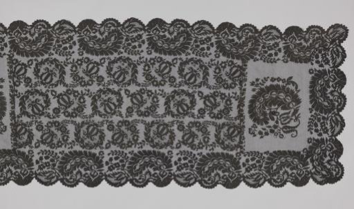Scarf of black bobbin lace with three rows of lyres (musical instruments)