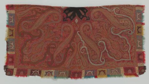 Square scarf of red twill wool with small black mirrors, surrounded by a full pattern of embroidered ornaments and colored blocks in red, yellow and blue along the edge