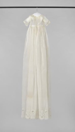 A Baptismal Gown of Glass Batiste with Scalloped Edges, with a Marigold Decoration