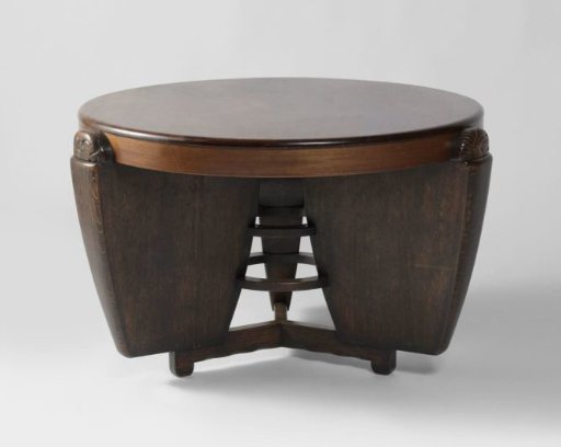 Table with a round tabletop with walls ending in carved masks