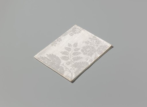 Napkin of linen damask with a lace pattern