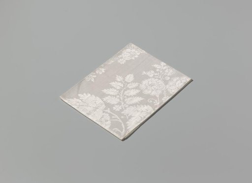 Napkin of linen damask with a lace pattern