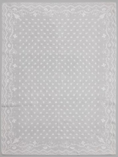 Napkin with scattered leaf motif and border with carnations