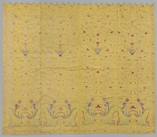 Curtain, part of a bed set, of yellow silk and embroidered with vases, floral scrolls, cornucopias, peacocks and butterflies in multicoloured silk