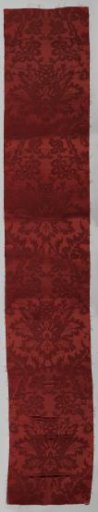 Fragment of red silk fabric; damask.