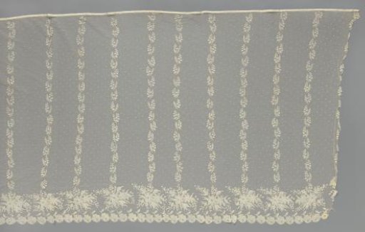 Skirt of a jacket of appliqué lace with vertical stripes of lilies of the valley springing from rose bouquets