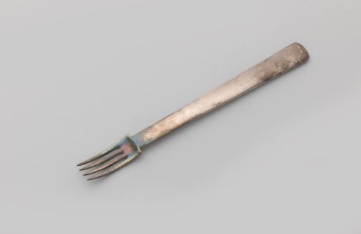 Fork with four tines and a handle widening towards the end