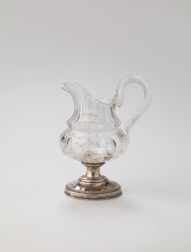 Milk jug of cut crystal with a silver foot