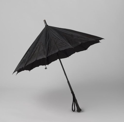Umbrella with a cover of black silk with an edge of machine-made brocade and tambour work, on a black wooden shaft with a square handle and a knob carved in relief