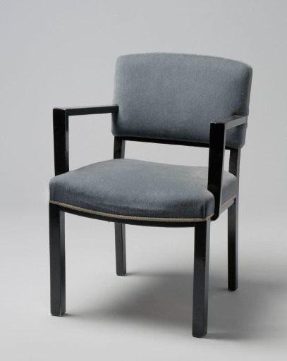 Armchair with angular armrests and upholstered in blue tripp