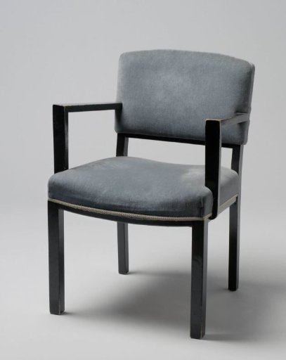 Armchair with angular armrests and upholstered in blue tripp