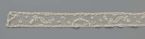 Strip of needle lace with mirrored S-shapes and arches