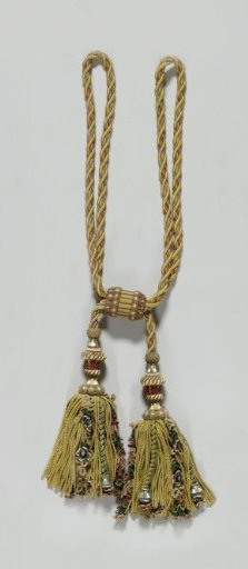 Curtain tieback belonging to a set of curtains with floral pattern on a yellow ground