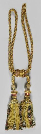 Curtain tieback belonging to a set of curtains with floral pattern on a yellow ground