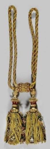 Curtain tieback belonging to a set of curtains with floral pattern on a yellow ground