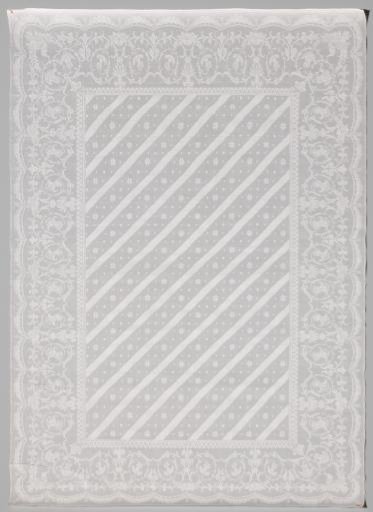 Napkin with diagonal stripes within volute border