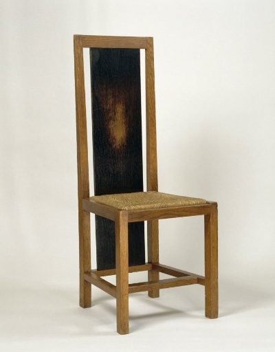 Chair with rush seat and elongated panel at the back