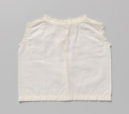 White linen child's shirt without sleeves, trimmed with a narrow border of English embroidery