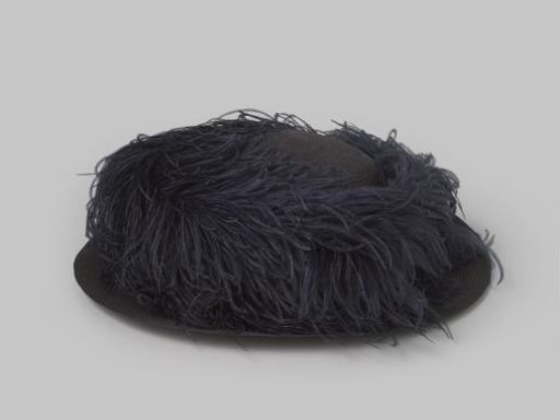 Hat of dark blue straw, with a dark blue ostrich feather