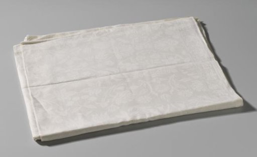 Tablecloth of white linen damask with a pattern of scattered flowers, cherries and insects