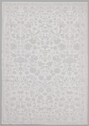 Napkin with pattern of wildflowers, cherries, insects including a grasshopper