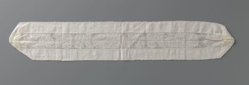 Insert of bobbin lace with a large oval peony between slanting leaves with a smaller peony, attached between the remnant of a linen cloth