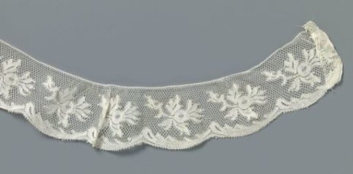Strip of machine-made lace with rosehip branch