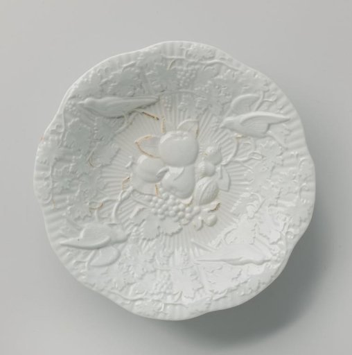 Fruit bowl, the flat surface with fruit and nuts in relief
