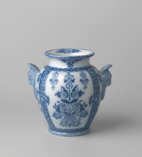 Vase decorated with floral and leaf work in blue, with two handles in the form of ram's heads