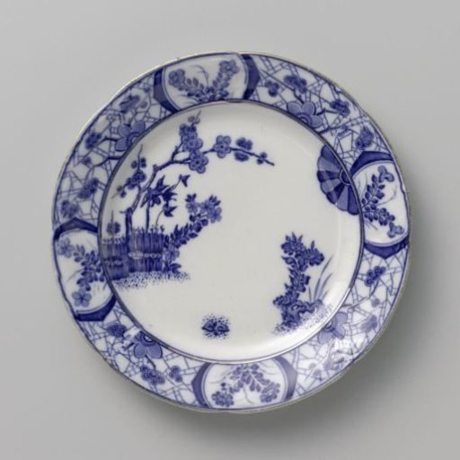 Platter with a plum tree behind a wicker fence and loose plants