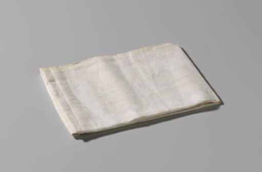 Napkin of white half-linen with an intricate pelican pattern