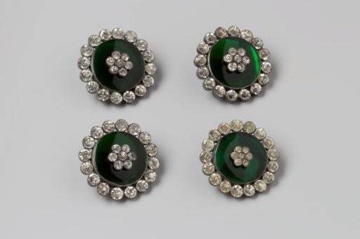Four decorative buttons of silver with green enamel and rhinestones