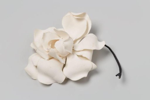 Corsage of white peony made of linen with stems of iron wire wrapped in green paper