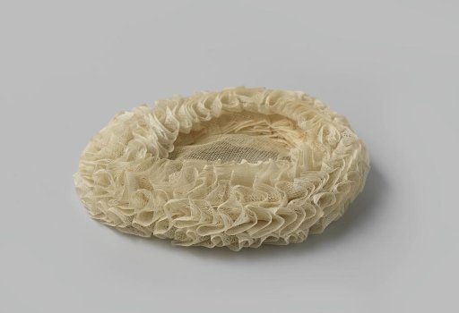 Maid's cap of tulle netting, consisting of a flat oval center surrounded by a triple, ruffled border