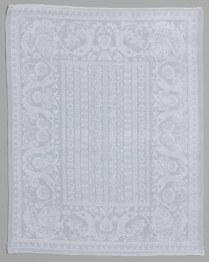 Damask napkin with ornamented lengthwise stripes within a border of volutes, flowers and a flower basket