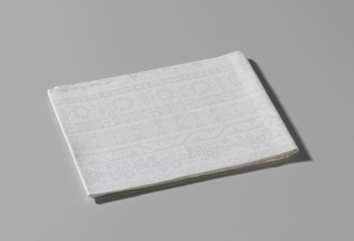 Damask napkin with ornamented lengthwise stripes within a border of volutes, flowers and a flower basket