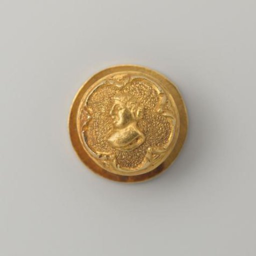 Gold shirt button with a man's portrait in a five-pointed star setting