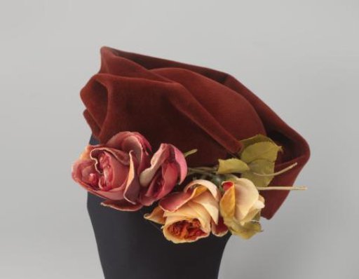 Hat of rust-brown, hairy felt with four flower corsages