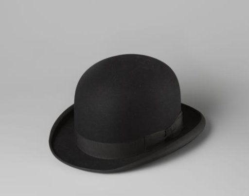 Bowler hat of black felt with a rolled-inward edge on the sides. Flattened dome from above with a number of star-shaped air holes in the middle