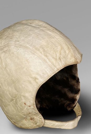 Motor cap of white leather with chin strap, fitted with fur ear warmers