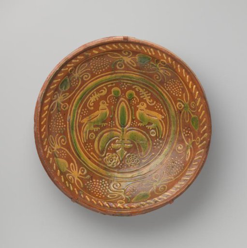Dish on three shell-shaped feet, decorated with birds, grapevines and grape clusters