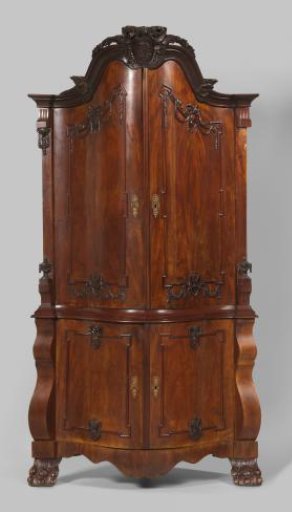 Corner cabinet of oak and Cuban mahogany with a vertically arched front