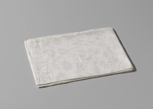 Napkin of white linen damask with the combined arms of Von Inn- und Kniphausen and Van Ewsum