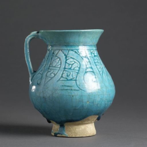 Pear-shaped ewer with an inscription and foliate scrolls