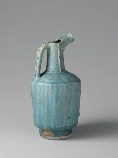Vessel or pitcher with fluted sides and incised scrolls