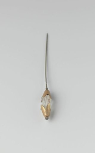 Hatpin of metal with a square piece of glass with bevelled sides, set between two flower-shaped mounts