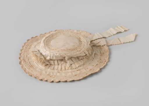 Children's hat of white cotton with flat crown and wide brim, decorated with cotton flower and matching pleated, scalloped ribbon with hanging ends