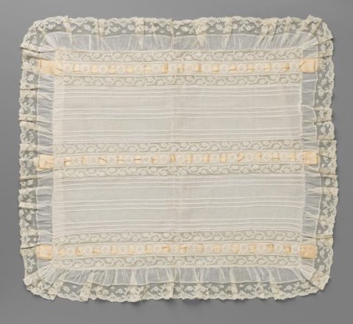 Tablecloth of batiste with light pink ribbons between machine embroidery and machine lace