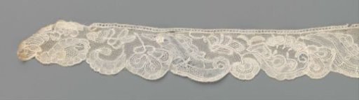 Strip of bobbin lace with alternating hanging flower and S-scroll