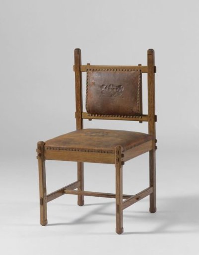 Oak chair upholstered in brown leather with a flower in the center of the seat and a branch on the back